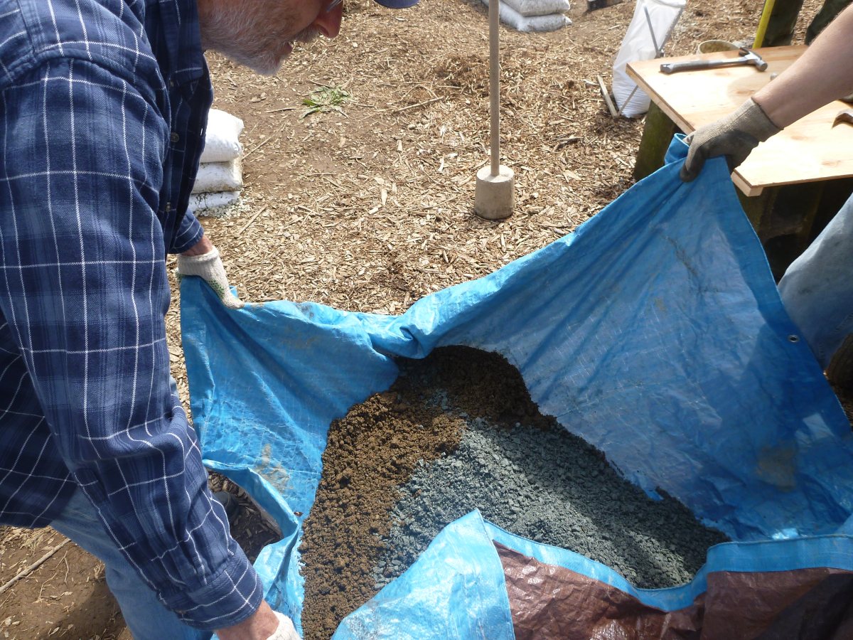 Mixing the earthbag fill of clay and gravel